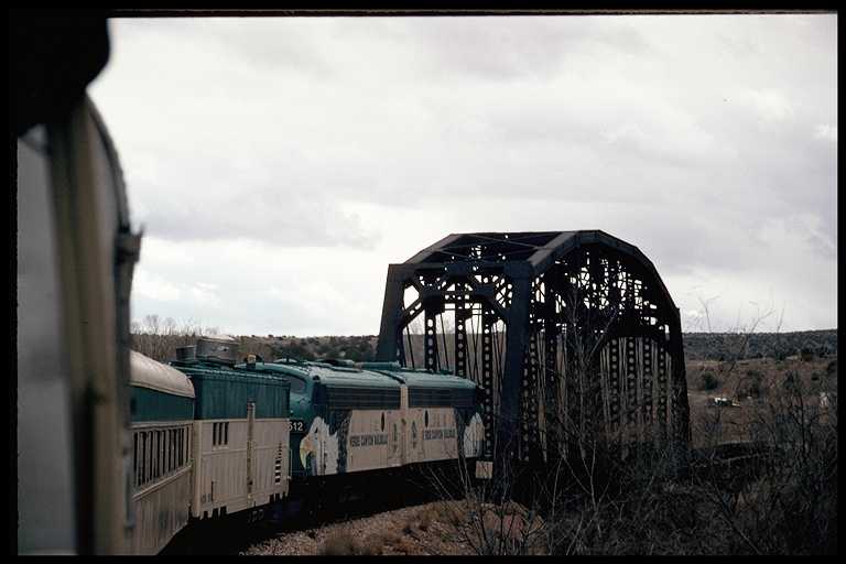 Passenger train crossing bridge over the Verde River.