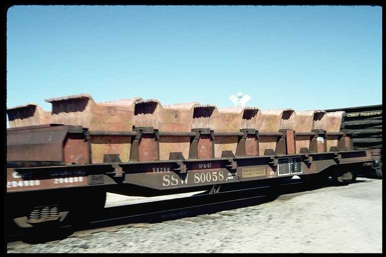 Flat car hauling a load of copper anodes produced by local copper mine.