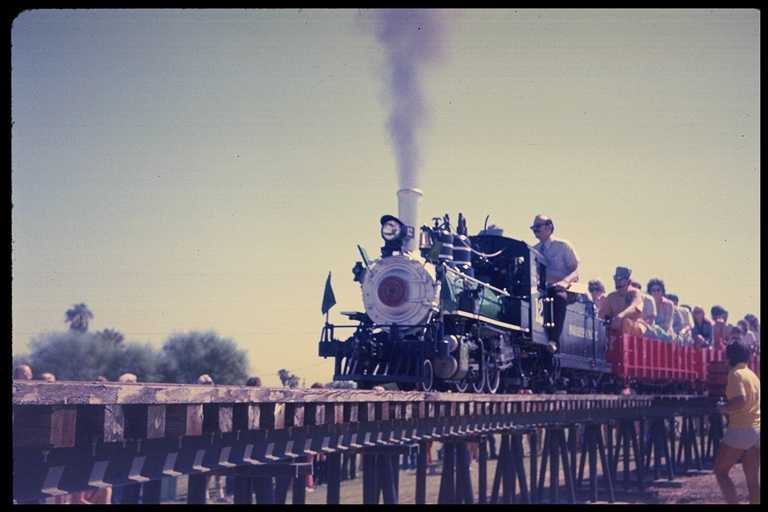 Photo of Paradise & Pacific locomotive on trestle with passengers.