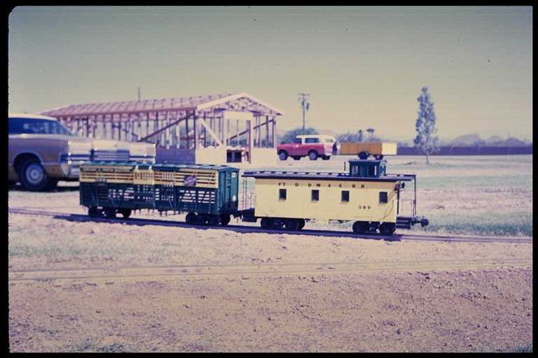 Photo of Paradise & Pacific caboose and freight car.