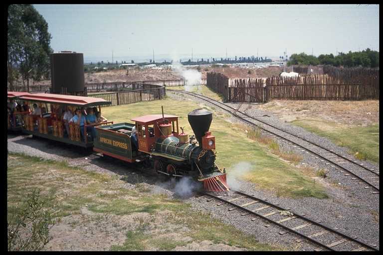 Photo of Legend City Amusement Park locomotive pulling passenger train.