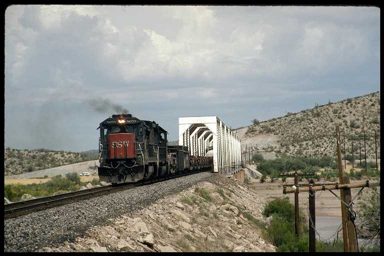 SP freight train crossing bridge near Coolidge.