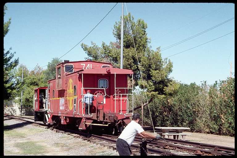 Switchman throwing track switch to move cars from one track to another.