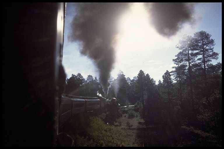 Photo of train working hard up grade.