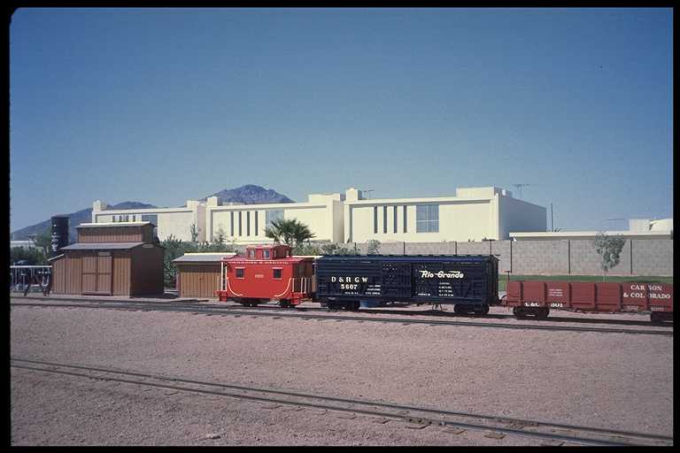 Paradise & Pacific RR caboose and freight cars.
